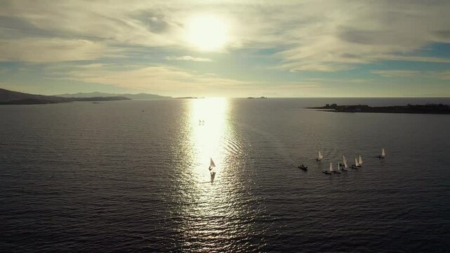 Drone shot of sail&iota;ng boats with sails outside of Parikia town on Paros island in Greece. 