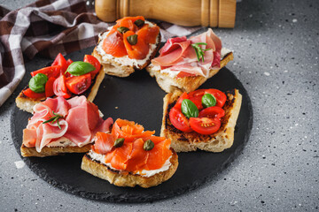 delicious Italian bruschetta with tomatoes salmon and prosciutto