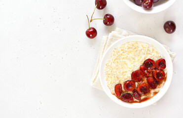 Oatmeal porridge with cherry slices in bowl