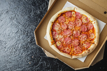 delicious pepperoni pizza with jalapeno peppers in a delivery box