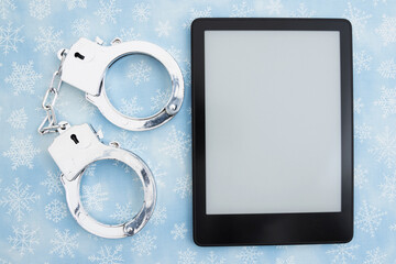 Cozy mystery reading with handcuffs and ereader