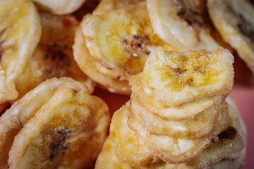 Macro shot of freeze-dried banana chips, highlighting their crunchy texture and golden yellow color. Perfect for food, snacks, and healthy eating themes.