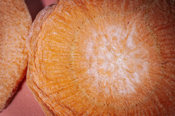 A macro shot of freeze-dried slices showcasing their deep, colorful hues, crunchy texture, and...