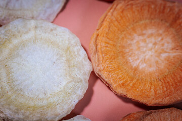 A macro shot of freeze-dried slices showcasing their deep, colorful hues, crunchy texture, and...