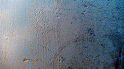 water drops on glass surface close up