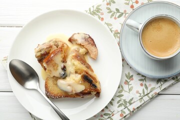 Freshly baked bread pudding and coffee on white wooden table, top view
