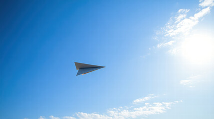 Fototapeta premium paper airplane soaring through clear blue sky, aiming for sun, evokes sense of freedom and creativity. bright sunlight enhances vibrant atmosphere