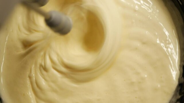 Mixing ingredients for a rich cake batter in the kitchen