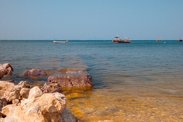 Infrared photography, a serene seascape with a clear blue sky and calm, azure waters
