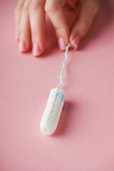 young girl holding a hygienic menstrual tampon hygiene concept