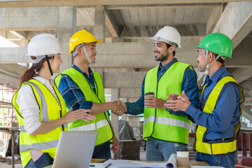 Engineer handshake,contractor on construction site to implement planning a new building,teamwork,contract property,real estate home project