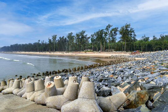 This picture depicts the scenic Shankarpur beach in the Bay of Bengal near Digha, India, where several Tetrapod breakwaters, a type of structure in coastal engineering, can be seen here