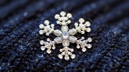 Obraz premium Sparkling snowflake brooch on dark knit fabric, winter holiday decoration