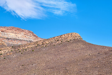 Space, dry and mountain with rugged terrain for outdoor adventure, conservation or geology. Blue sky, ecology mockup and nature with in rocky environment for canyon discovery, peak or exploration
