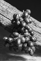 Grapes in the air with wooden background .