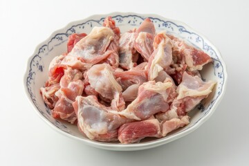 Raw Chicken Gizzards and Liver Displayed in Bowl Under Bright Overhead Lighting Against a White Background, Perfect for Culinary or Food Photography