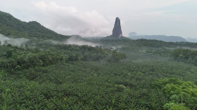 Sao Tome and Principe - Aerial View of Pico Cao Grande. Majestic Volcanic Needle Towering Over Dense Tropical Rainforest.
