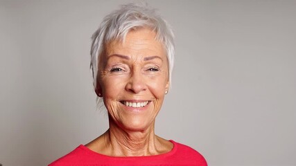 happy senior woman with short gray white hair smiling and blinking - Powered by Adobe
