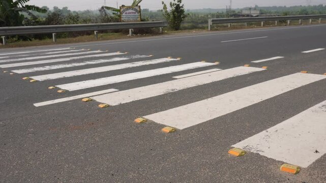 Zebra crossing, also known as a marked crosswalk, designed to facilitate safe pedestrian passage across a road.