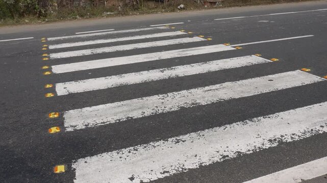Zebra crossing, also known as a marked crosswalk, designed to facilitate safe pedestrian passage across a road.