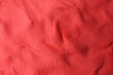 Red play dough as background, top view