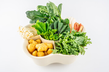 A plate of hot pot vegetables on a white background