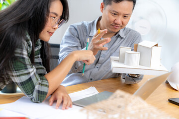 Two young architects working at the office.