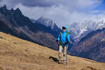 Backpacking woman hiking on high altitude mountain top
