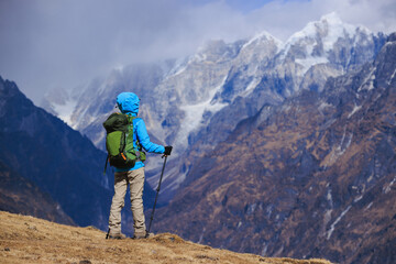 Backpacking woman hiking on high altitude mountain top