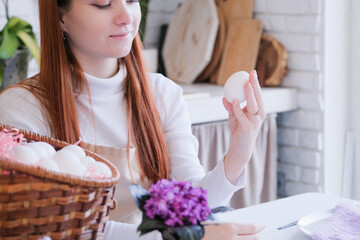 woman holding white easter egg , getting ready for Easter