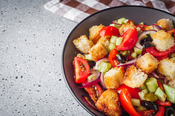 delicious traditional Italian panzanella salad on a stone rustic background
