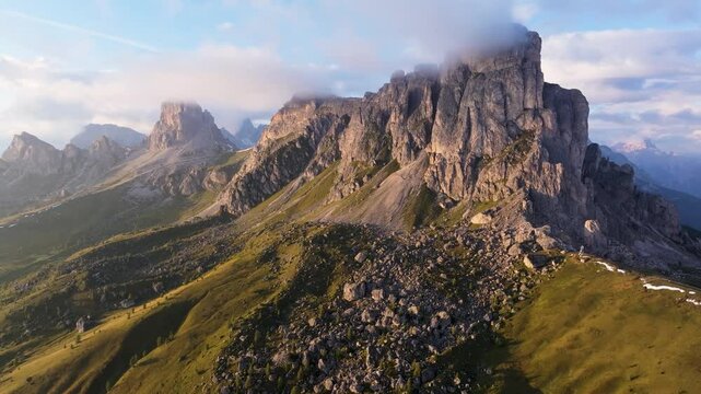 Aerial view of majestic dolomites with rocky peaks and tranquil clouds at passo giau, Colle Santa Lucia, Italy.