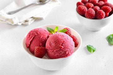 Homemade raspberry ice cream scoop with fresh raspberries