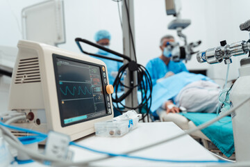 Skilled surgeon and his medical team performs precise eye surgery on an elderly patient, restoring...