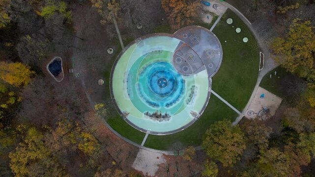 Aerial view of a beautiful circular park surrounded by trees in autumn colors, Plaenterwald, Berlin, Germany.