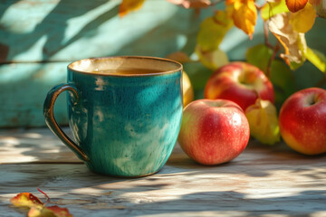 Cup of french cider with apples on wooden table in the garden with autumn sun light