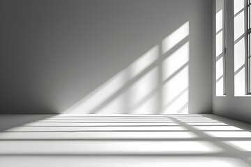 Obraz premium A minimalist interior scene featuring a bright room with soft shadows created by sunlight filtering through large windows. The space evokes a calm and serene atmosphere.