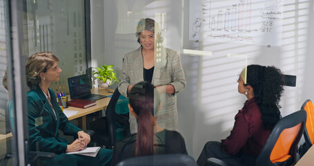 Indian young adult female old elder older boss lady team leader show growth chart white board learn graph data work place teen girl intern expert group talk share stock trade speak idea job office day