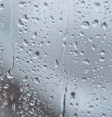 The glass is covered with raindrops. Macro photo