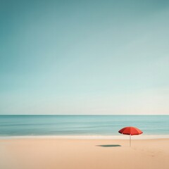 Solitary red umbrella on tranquil beach with clear sky and calm sea