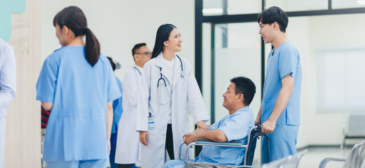 Healthcare and medical concept Happy asian woman doctor talking health with old patient in wheelchair in hospital ward