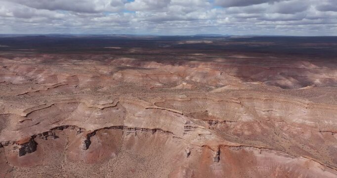 Aerial panoramic view of epic high cliffs, ravines and very old geological rock formations. Chubut, Argentina