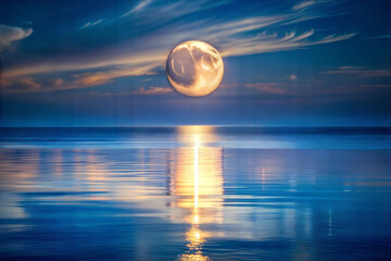 the-moon-reflecting-in-a-calm-ocean-at-night