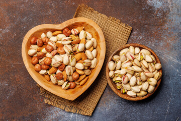 A vibrant mix of various nuts, including almonds, walnuts, hazelnuts, cashews, and pistachios