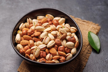 A vibrant assortment of various nuts, including almonds, walnuts, hazelnuts, cashews, and pistachios