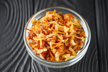 crispy golden fried onions on a wooden rustic background