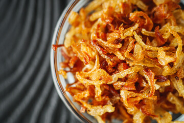 crispy golden fried onions on a wooden rustic background