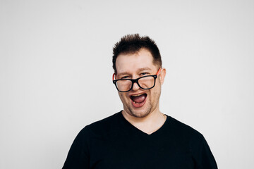 A man in a black t-shirt and glasses goofing around on camera. Crazy guy