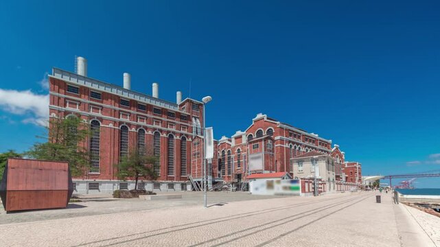 Hyperlapse of EDP Electricity Museum (former power plant) and MAAT by the Tagus River. Lisbon cityscape timelapse with iconic landmarks blending history and modern architecture. Portugal