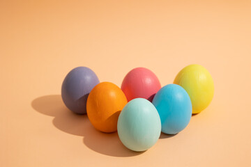 Easter eggs of various colors on a light background, Easter celebration concept